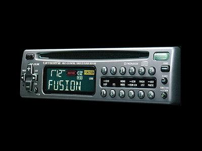 1990s car dashboard with a CD player, showing digital display and multi-disc changer.