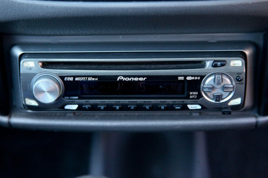 2000s car dashboard showing Pioneer CD player