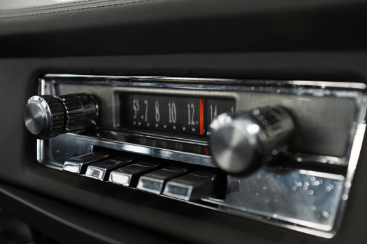 Vintage 1960s car dashboard with classic Blaupunkt radio player symbolizing the golden era of in-car music.
