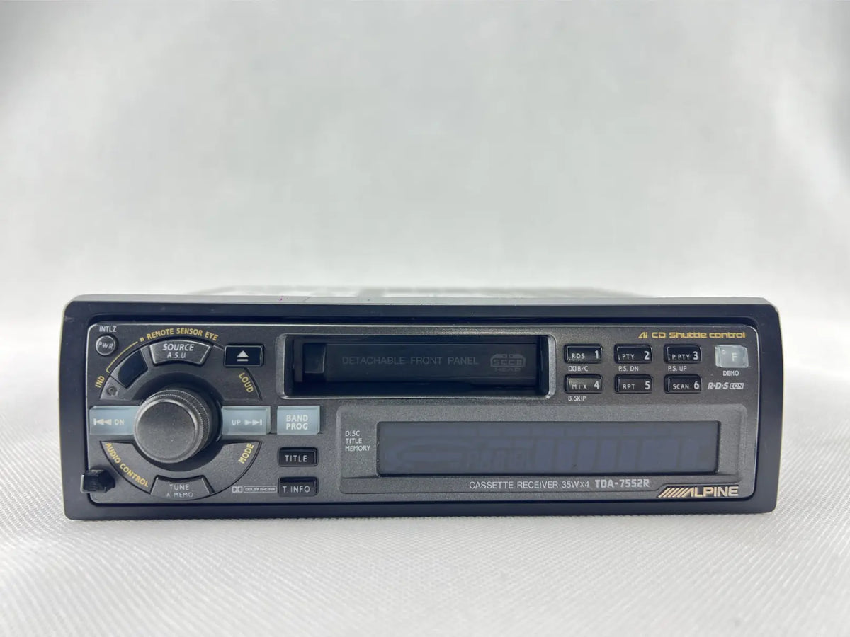 Straight front view of the Alpine TDA-7552R cassette radio and original control panel