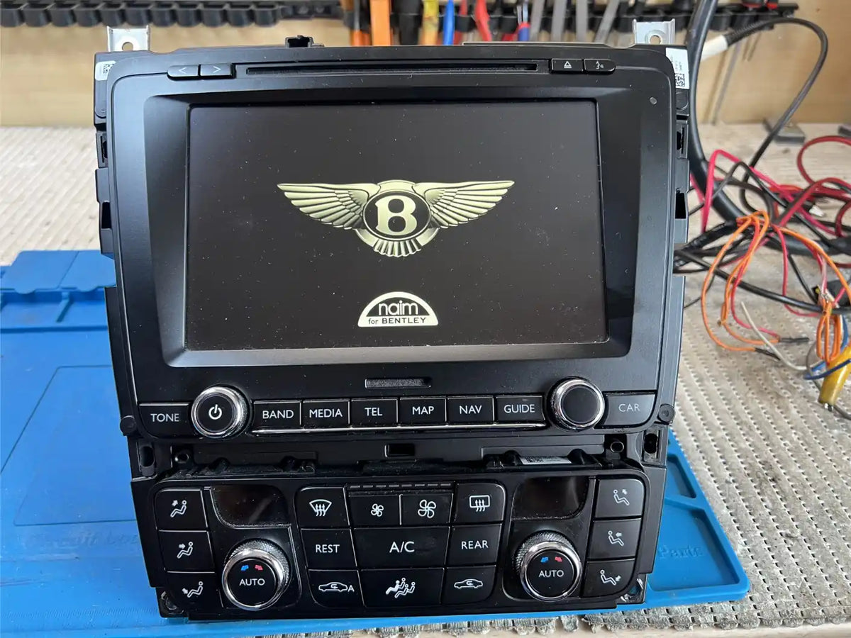 Bentley RNS 810 multimedia unit powered on during workshop bench testing