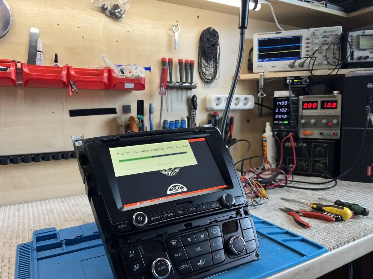 Bentley RNS 810 multimedia system undergoing functional testing after repair