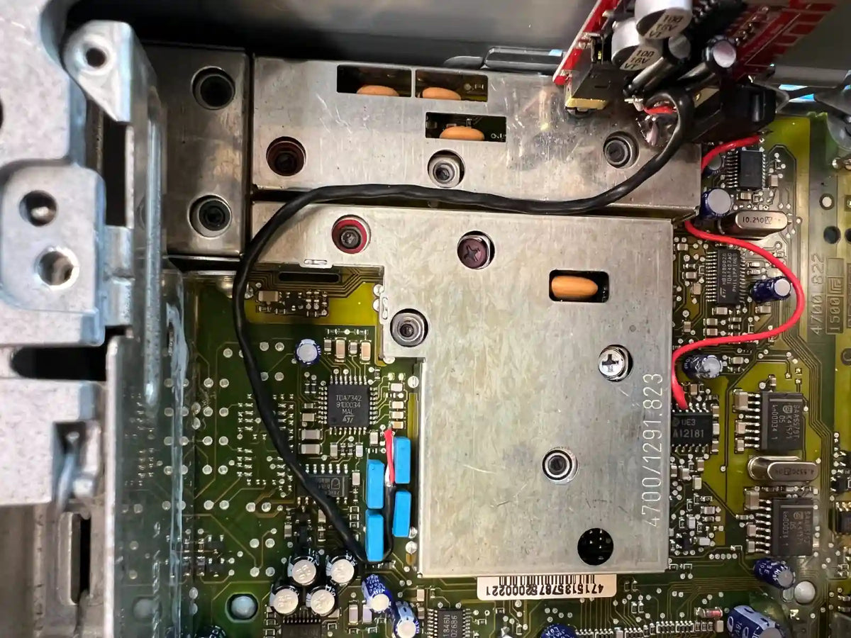 Internal Bluetooth module installed inside car radio with wiring integrated into original electronics