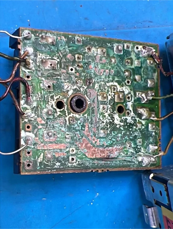 Corroded car radio circuit board before electronic repair