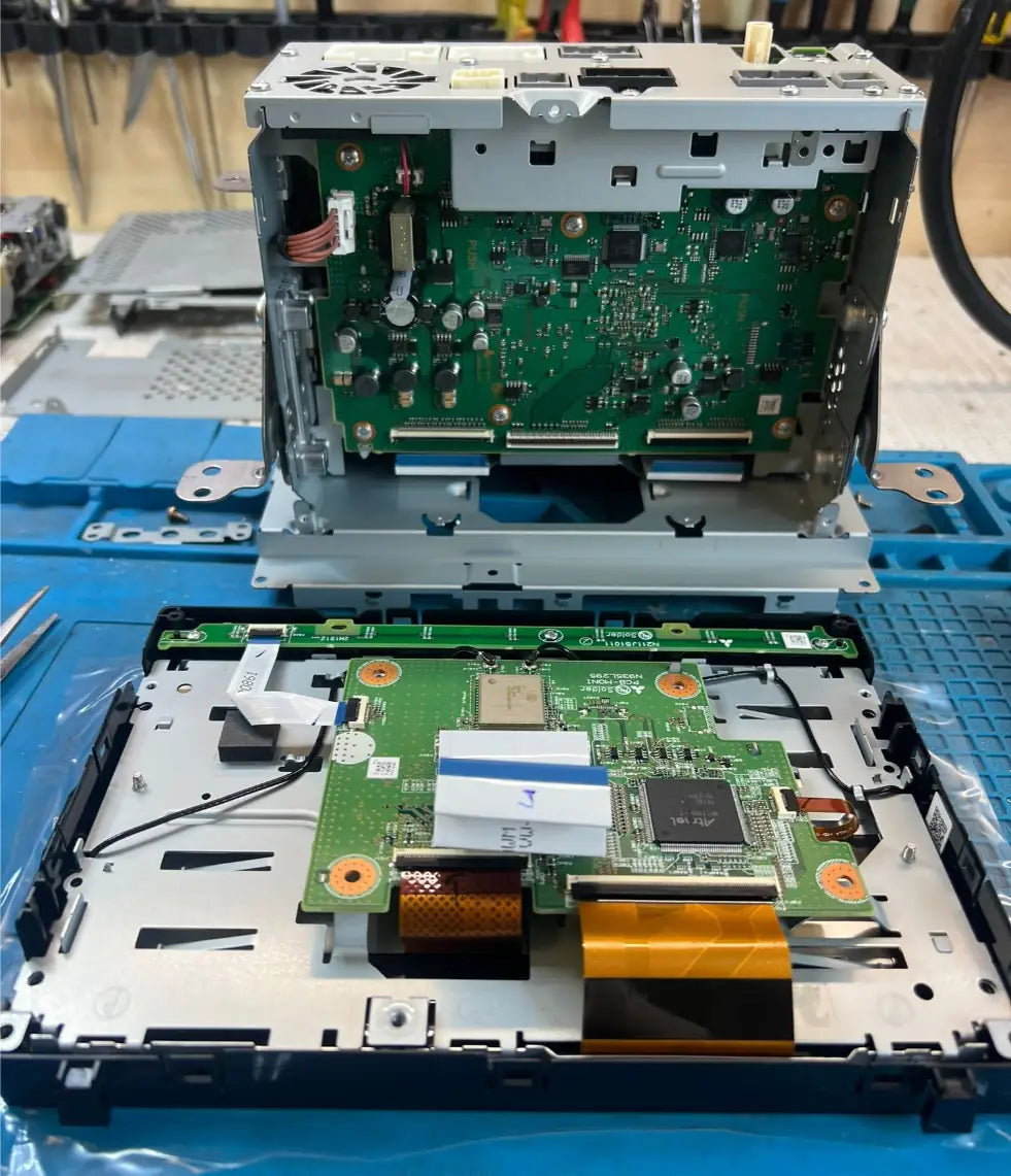 Mitsubishi Outlander OEM radio unit opened showing internal mainboard and display connectors