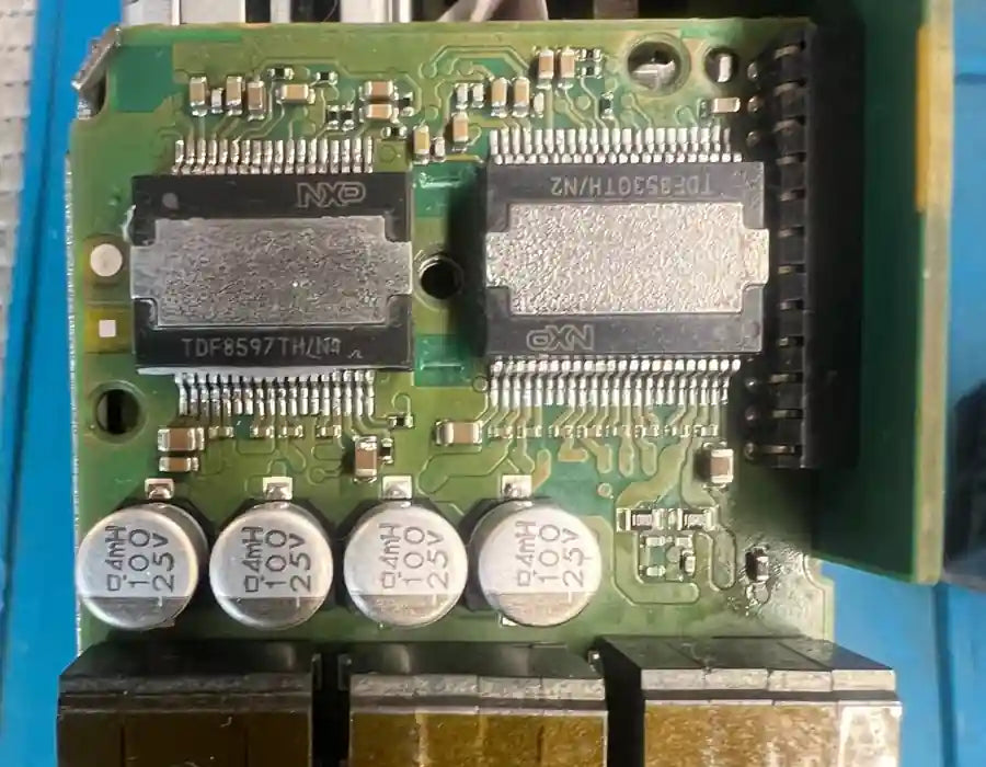 VW Audi Harman MMI amplifier IC chips showing thermal stress during multimedia repair process